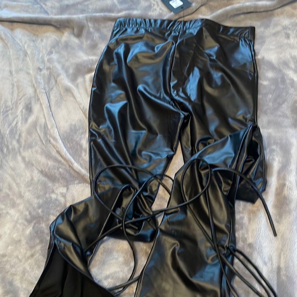 Black leather pants stings wrap around ankle with a hem bottom fashionnova